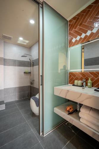 a bathroom with a sink and a shower at Weal Apartment in Danang