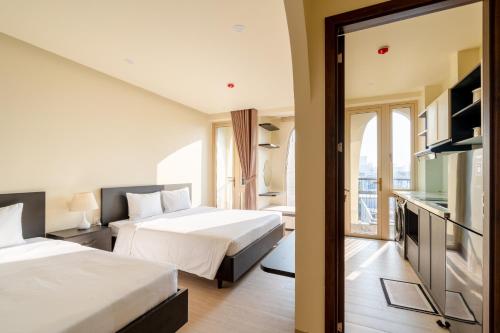 a hotel room with two beds and a window at Weal Apartment in Danang
