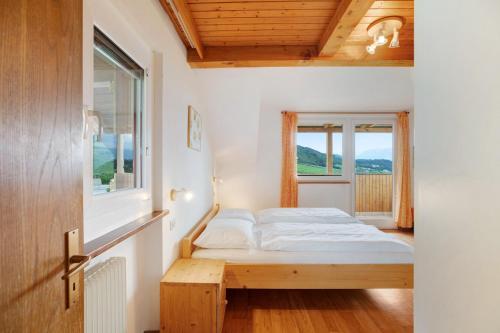 a bedroom with a bed and a window at Harmony Apt 1 in Appiano sulla Strada del Vino