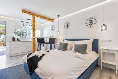 a bedroom with a large bed and a kitchen at Chabelas Loft in Lajita