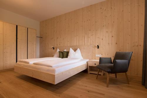 a bedroom with a bed and a desk and a chair at Greiterhof in Lana