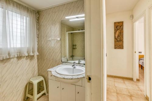 a bathroom with a sink and a mirror at Roses Sweet Home in Roses