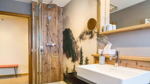 a bathroom with a sink and a shower at Ferienhaus Unmüßig in Hinterzarten