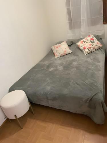 a bed with two pillows on it in a room at Les evettes 4-6 couchages in Flumet