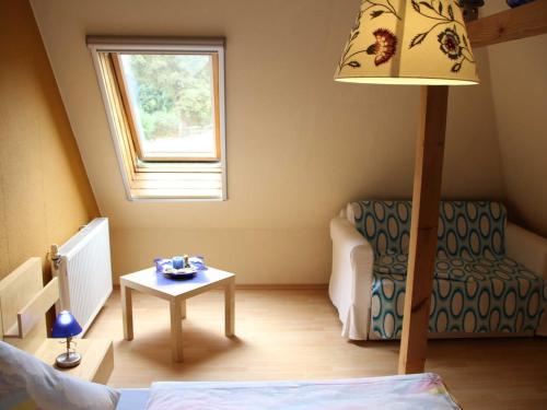 a room with a bed and a table and a lamp at Ferienwohnung an der Müritz in Klink