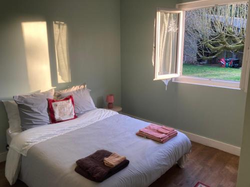 a bedroom with a bed with two towels on it at Maison David in Nantiat
