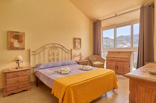 a bedroom with a bed and a large window at Casa Fuentes 2 B2 in Almuñécar