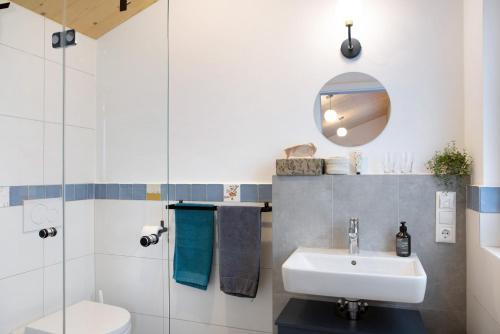 a bathroom with a sink and a toilet at Refugium aus Vollholz in Schlitz