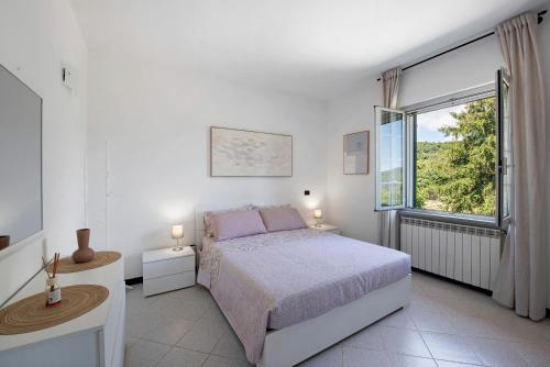 a bedroom with a bed and a large window at Ai campi in Stella