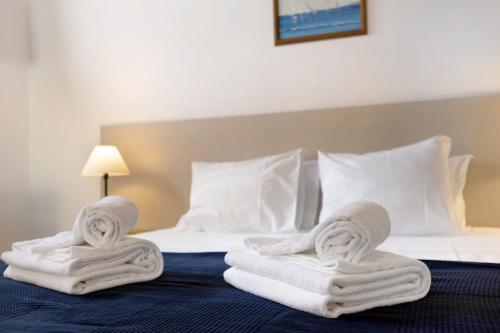 a hotel room with towels on a bed at A Cerca - A in Lagos