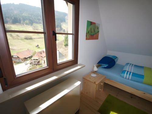 a room with a window with a blue bench in front of it at Ferienhaus Paula in Forbach