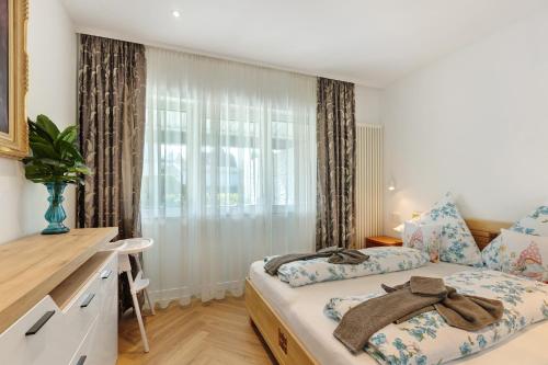 a bedroom with a bed and a window at Ferienwohnung Reichenau in Reichenau