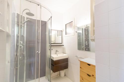 a bathroom with a glass shower and a sink at Résidence Aria Marina Plage in Ajaccio