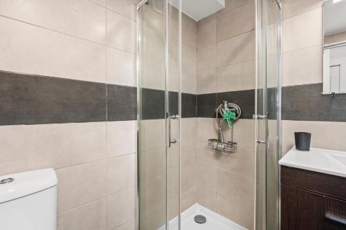a bathroom with a shower and a toilet and a sink at Sunset Studio in Alvor