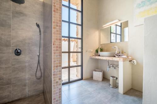 a bathroom with a shower and a sink at Casa Cascada in Costitx