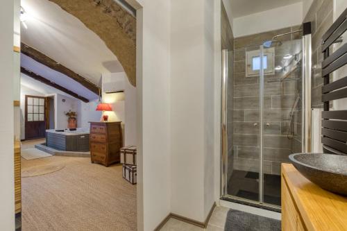 a bathroom with a glass shower and a sink at Forgerole in Faugères