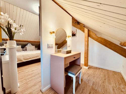 a bathroom with a vanity and a bed in a room at Lot54 Holiday Homes in Feuerscheid