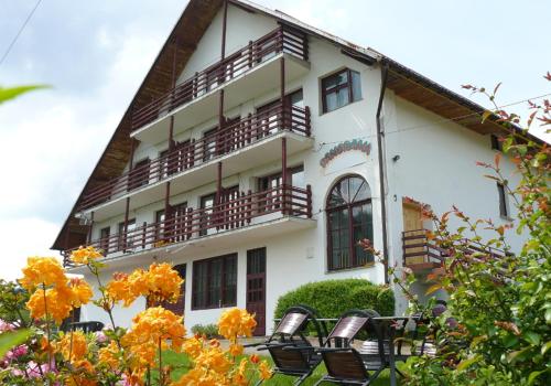 a building with balconies and chairs in front of it at Panorama in Korbielów