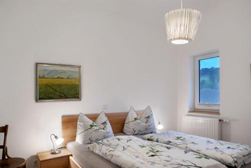 a bedroom with a bed and a window at Sand 68 in Steinau an der Straße