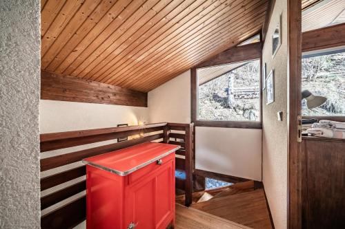 a red cabinet in a room with a window at Chalet Châtel - calme et spacieux in Châtel