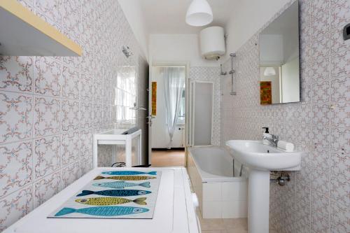 a bathroom with a sink and a bath tub next to a sink at Porta Delle 5 Terre in Levanto