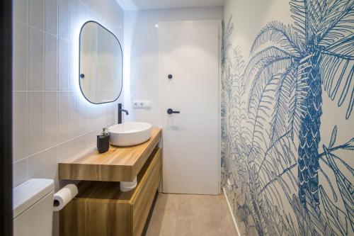 a bathroom with a sink and a mirror at La Calma in Platja d'Aro