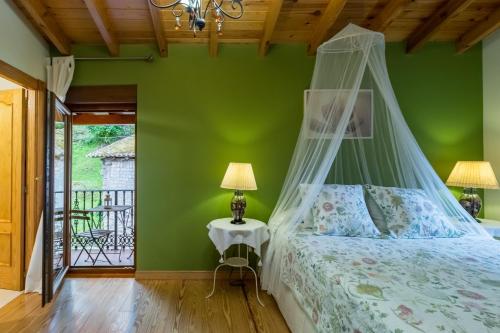 a bedroom with a bed with a canopy at Casa Lindelagua in Pámanes