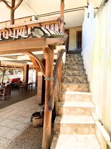 a set of stairs in a building with a wooden structure at Santai Surf Lodge-Balangan in Uluwatu