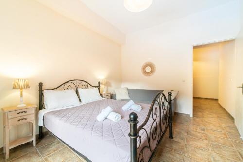 a bedroom with a large bed and a night stand at Arianna Studio 15 in Paleokastritsa