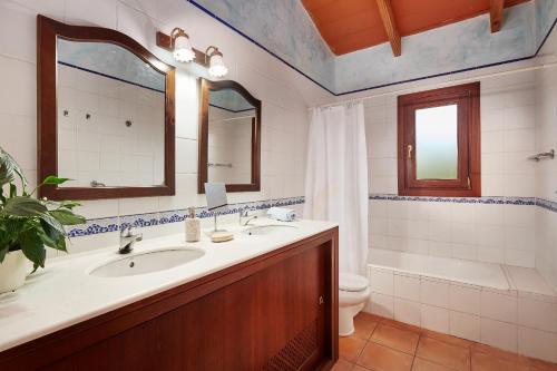 a bathroom with a sink and a toilet and a tub at Casa Tolo in Son Servera