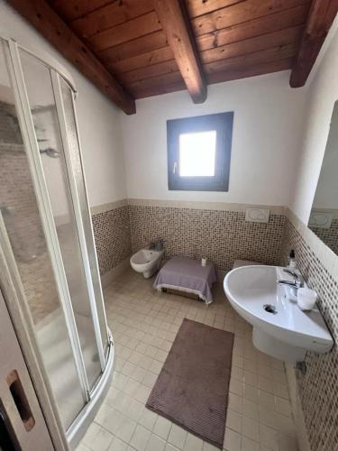 a bathroom with a shower and a sink and a toilet at Orizzonti 32 in Golfo Aranci