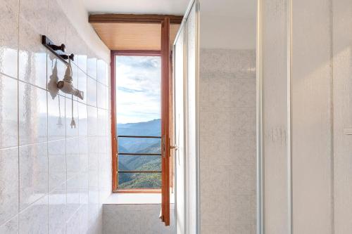 a bathroom with a window and a shower at Silent View - Unità 18 in Baiardo