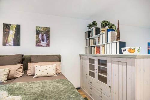 a bedroom with a bed and a book shelf at Ferienwohnung Eifelzauber in Greimerath