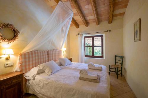 a bedroom with a bed with a mosquito net at Son Reus in Felanitx