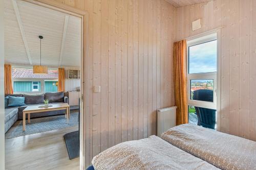 a bedroom with a bed and a view of a living room at Skipper-Lodge West in Kosel