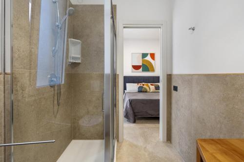 a bathroom with a shower and a bedroom with a bed at I Tramonti Del Golfo - Kennedy in Balestrate