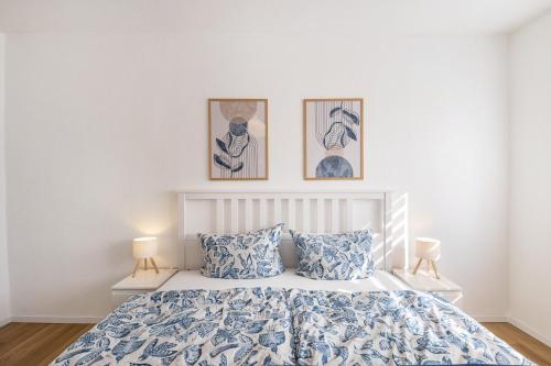 a bedroom with a bed with two pictures on the wall at Ferienwohnung Mücheln in Mücheln