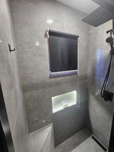 a bathroom with a flat screen tv on the wall at Happy stay297 in Paradera