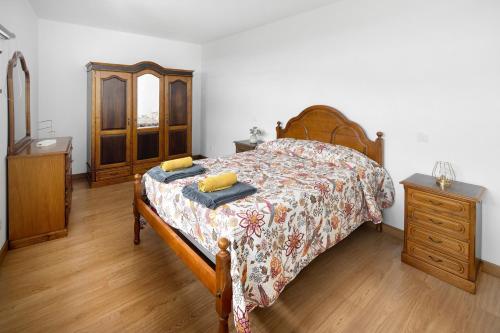 a bedroom with a bed and a wooden dresser at Casa Caminho da Esperança in Porto Judeu