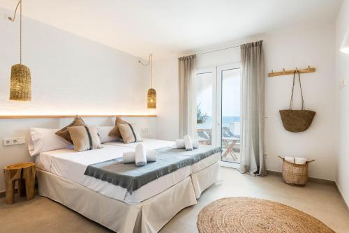 a bedroom with a bed with a view of the ocean at Villa Atalis in Menorca