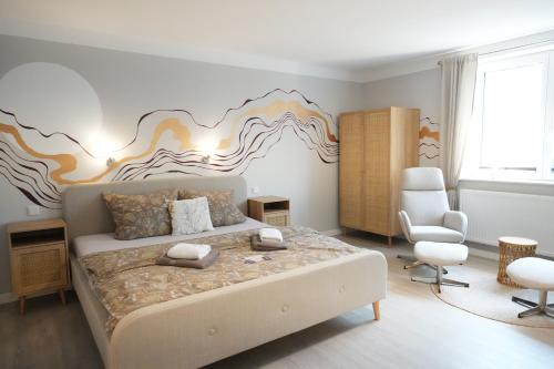 a bedroom with a bed with a mural on the wall at Haevn Erholung, Feuer, Wasser, Luft in Reußenköge
