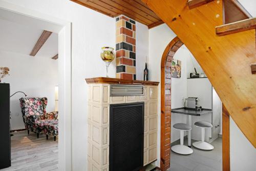 a living room with a fireplace and a table at Ferienhaus Engert mit Holzofensauna in Althüttendorf