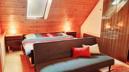 a bedroom with two beds and a couch in it at Haus am Ring in Spielberg