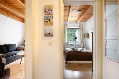 a hallway leading to a living room with a bed at Green Oasis Ferienwohnung in Treia