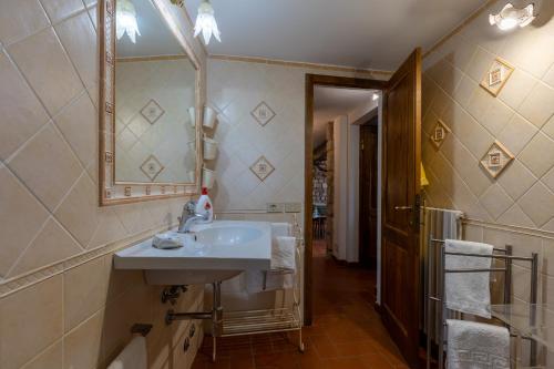 a bathroom with a sink and a mirror at La Petrosa in Radda in Chianti