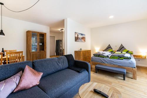 a living room with a couch and a bed at Grötacker Wohnung 6 in Husby