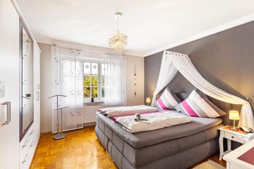 a bedroom with a bed with a canopy at Ferienwohnung Sommersonne in Warstein