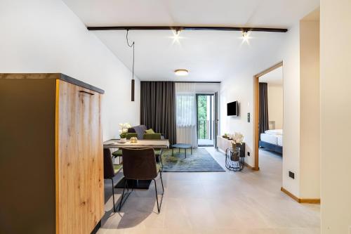 a living room and dining room with a table and a bed at Apartment Pauli in Lagundo