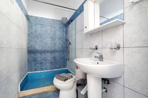 a bathroom with a sink and a toilet at Iguana studio 11 in Preveza