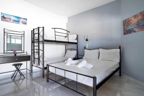 a bedroom with two bunk beds and a desk at Iguana studio 11 in Preveza